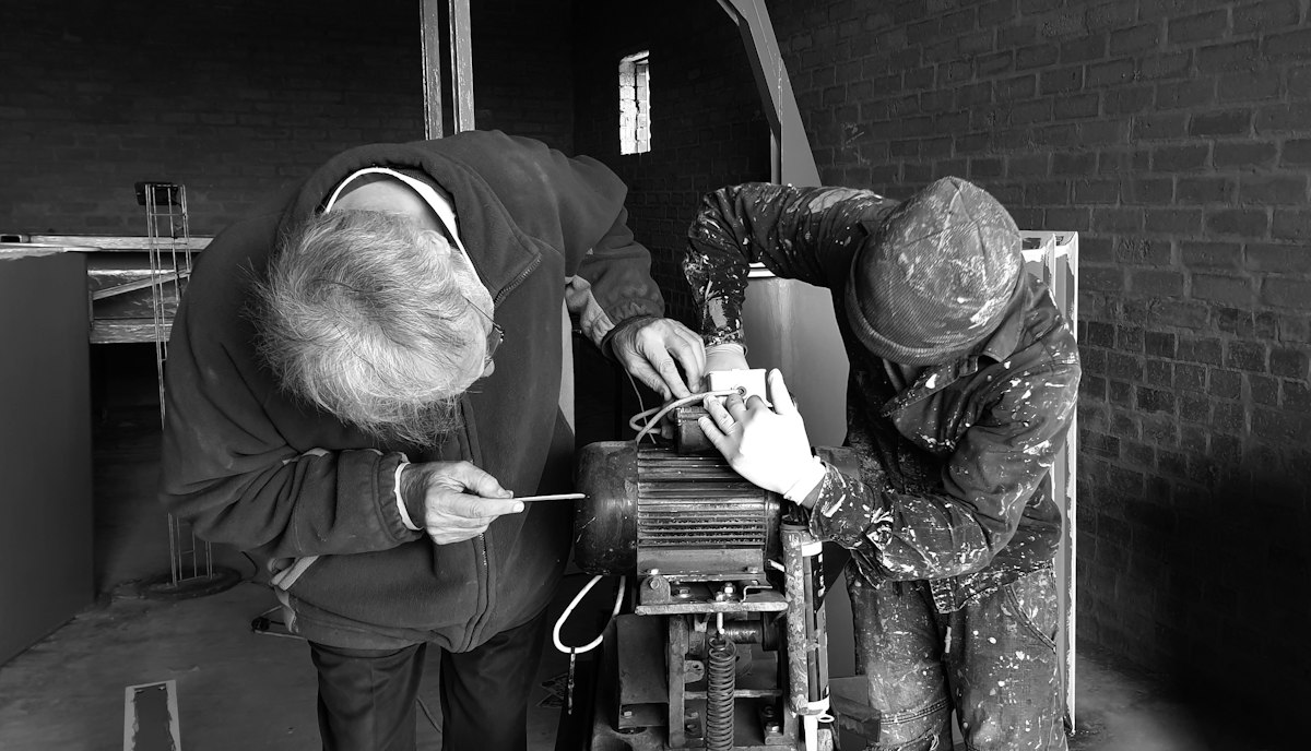 Licensed HVAC technician servicing a reverse cycle outdoor unit in Adelaide